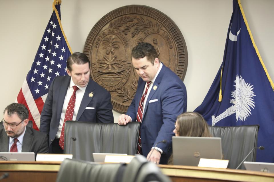 South Carolina Reps. Bobby Cox, R-Greer, left, and Micah Caskey, R-Springdale, right, look at a version of a bill that would allow open carry of guns on Tuesday, March 5, 2024, in Columbia, S.C. (AP Photo/Jeffrey Collins)