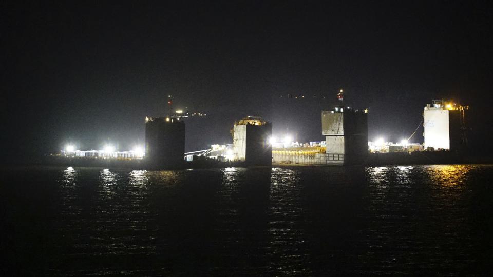 In this photo provided by South Korean Maritime Ministry, two barges attempt to salvage the sunken Sewol ferry in waters off Jindo, South Korea, Wednesday, March 22, 2017. South Korean workers on Wednesday began the difficult process of raising a 6,800-ton ferry that sank in 2014, killing more than 300 people and triggering a public uproar that contributed to the recent ouster of Park Geun-hye as president. (South Korean Maritime Ministry via AP)