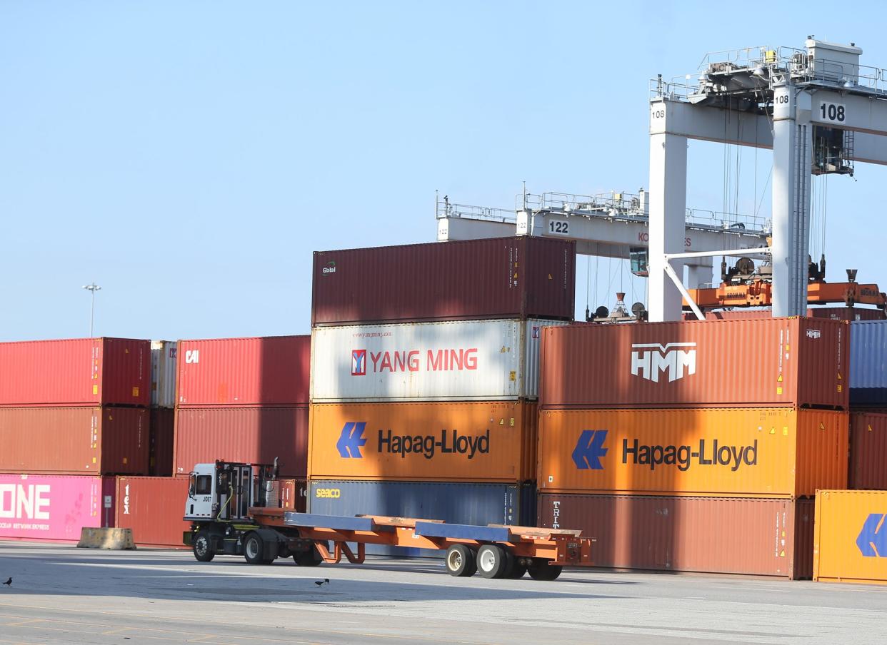 A jockey truck drives past stacks of containers at the Georgia Ports Authority Garden City Terminal.