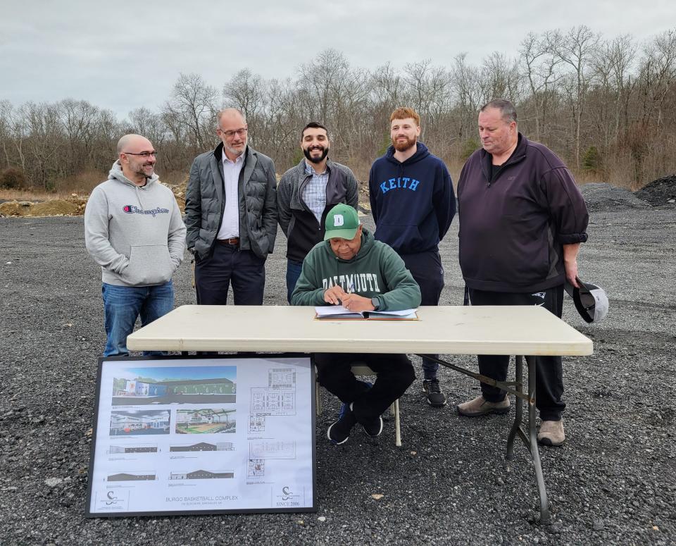 Steven Burgo (seated) signs a 30-year lease in front of (left to right) BBA board members Ray Medeiros, Alekz Hirschmann, Preston LaBonte and Graham Gisherman and Dartmouth Select Board Vice Chair Shawn McDonald.