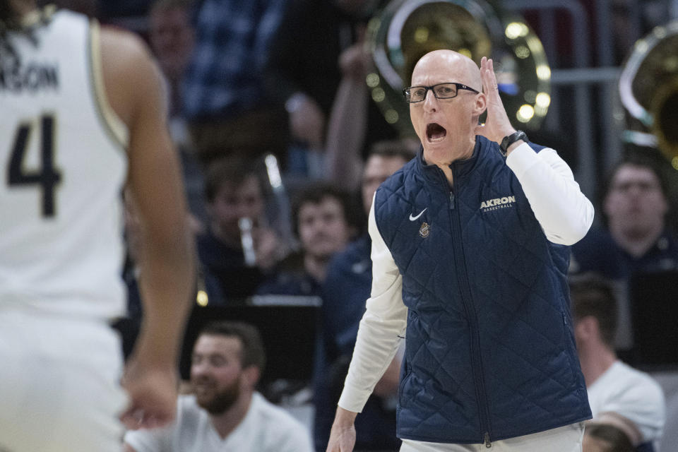 Akron head coach John Groce yells instructions to his team against Kent State during the first half of an NCAA college basketball game in the championship of the Mid-American Conference tournament, Saturday, March 16, 2024, in Cleveland. (AP Photo/Phil Long)
