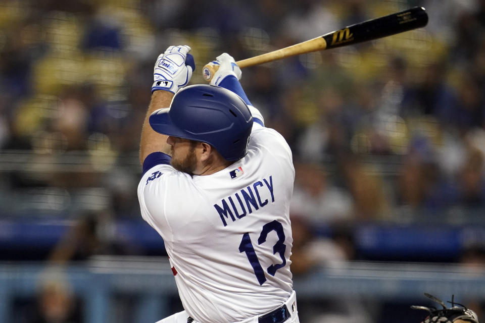 Los Angeles Dodgers' Max Muncy follows through on a double during the first inning of a baseball game against the Arizona Diamondbacks Tuesday, Sept. 14, 2021, in Los Angeles. (AP Photo/Marcio Jose Sanchez)