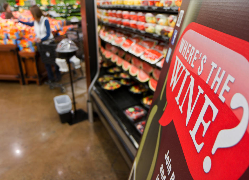 In this Friday, Nov. 30, 2012 file photo, a sign in a Kroger supermarket in Nashville, Tenn., urges shoppers to sign up for a group urging lawmakers to change state law that limits wine sales to liquor stores. (AP Photo/Erik Schelzig)