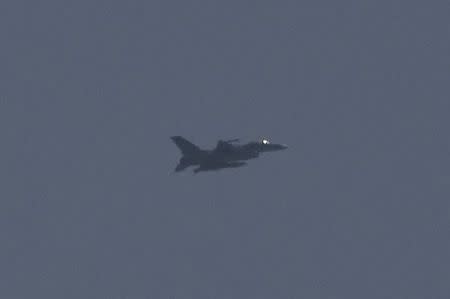 A fighter jet flies above Egypt's North Sinai as seen from across the border in southern Israel July 2, 2015. REUTERS/Amir Cohen