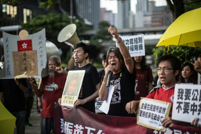 Leung Kwok-hung (C), of the League of Social Democrats, at a rally in Hong Kong on July 1, 2015, on the sidelines of the flag raising ceremony to mark the anniversary of Hong Kong's handover from Britain to China