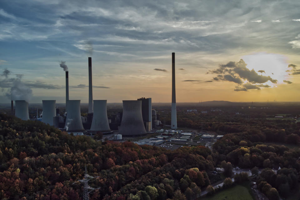 FILE - The sun sets behind the cole-fired power plant 'Scholven' of the Uniper energy company in Gelsenkirchen, Germany, on Oct. 22, 2022. The European economy contracted slightly at the end of last year and beginning of 2023, revised figures showed Thursday June 8, 2023, underlining the impact of the loss of Russian natural gas and high inflation on consumer spending. (AP Photo/Michael Sohn, File)