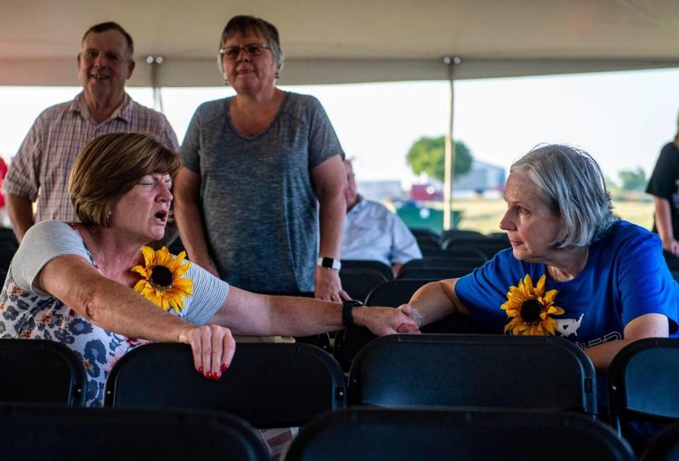 Attendants pray together at the Prayer at the Heart of America event in Lebanon, Kan., Friday, July 22, 2021. Throughout the event speakers prayed for forgiveness and healing of America.