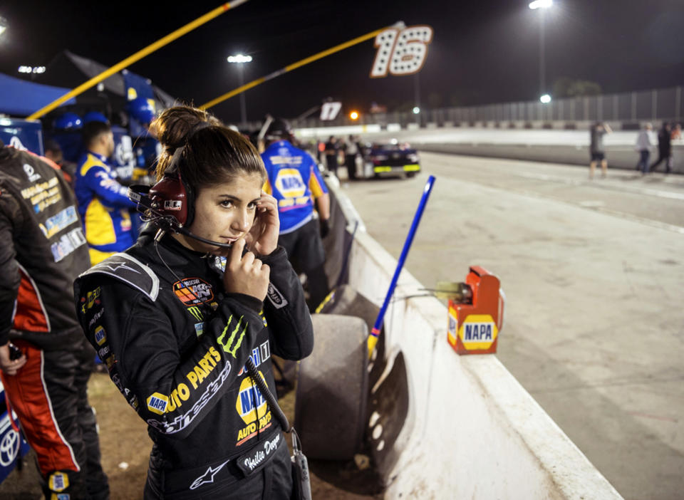 FILE - In this file image taken Feb. 11, 2018 and provided by Connexions Sports and Entertainment, NASCAR K&N Pro Series East driver Hailie Deegan stands in the pits at the New Smyrna Speedway in New Smyrna Beach Fla. On Saturday, Sept. 29, 2018, Seventeen-year-old Deegan used a bump-and-run on her teammate to become the first female winner of a NASCAR K&N West Series race. (Chris Garrison/Connexions Sports and Entertainment vis AP, File)