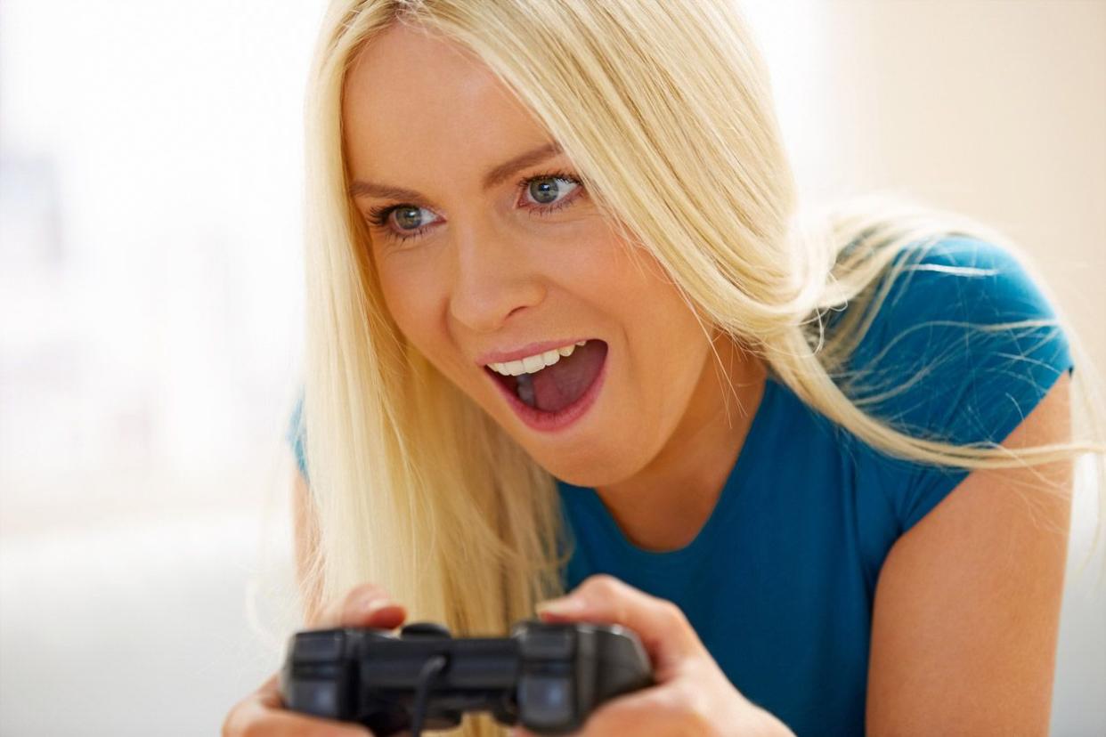woman excitedly playing video game