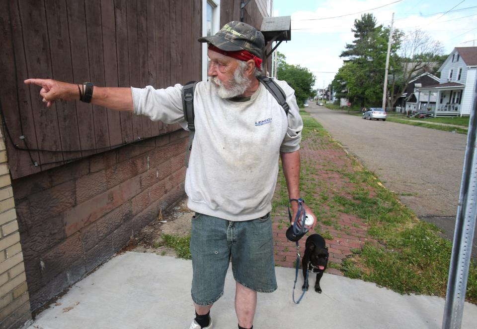 Tim Stuchell speaks about the lack of full-service grocery stores in his area of Alliance. Along with him for a walk was his four-legged friend Bella Marie.