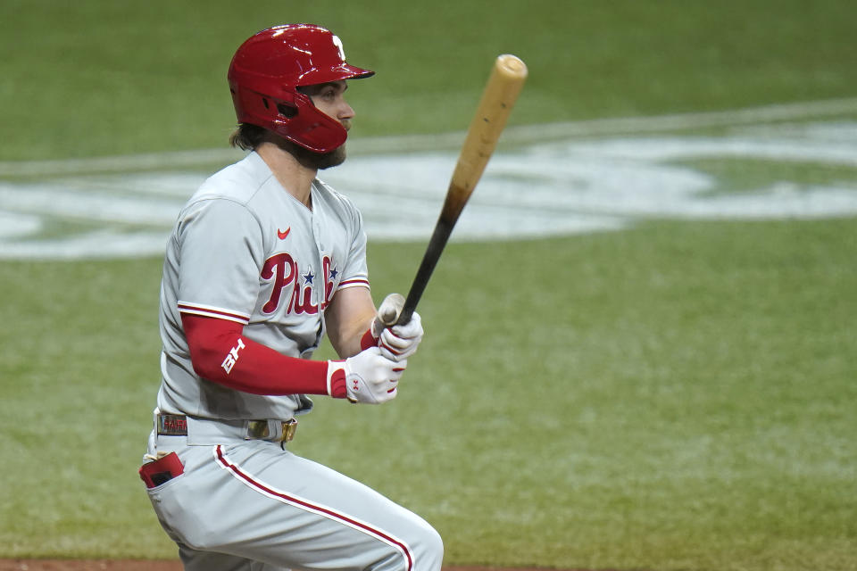 Philadelphia Phillies' Bryce Harper lines an RBI triple off Tampa Bay Rays starting pitcher Charlie Morton during the third inning of a baseball game Friday, Sept. 25, 2020, in St. Petersburg, Fla. Phillies' Alec Bohm scored on the play. (AP Photo/Chris O'Meara)