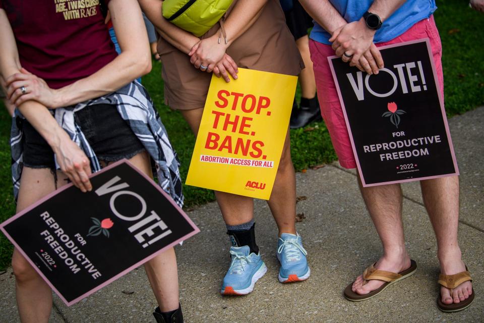 People hold signs at the Monroe County Courthouse on Wednesday, Sept. 14, 2022 during the We Are Hoosiers: A Vigil for Reproductive Freedom demonstration before the near total abortion ban goes into effect on Sept. 15, 2022.