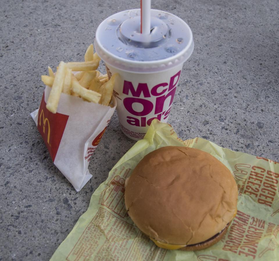 McDonald's small cheeseburger meal with fries and coke.