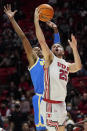 UCLA guard Peyton Watson, left, defends against Utah guard Rollie Worster (25) during the second half of an NCAA college basketball game Thursday, Jan. 20, 2022, in Salt Lake City. (AP Photo/Rick Bowmer)