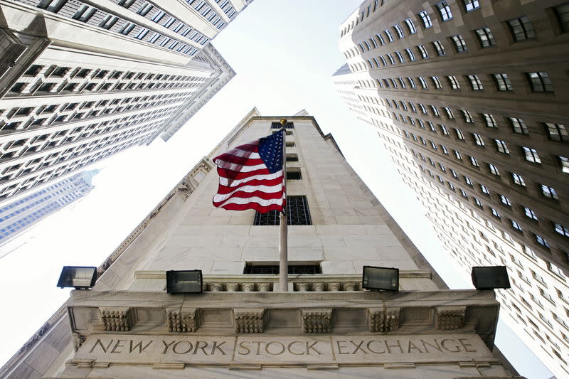 A U.S. flag hangs above an entrance to the New York Stock Exchange August 26, 2015. REUTERS/Lucas Jackson