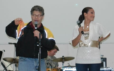 Al Franken and Leann Tweeden entertain the Soldiers with a skit at Forward Operating Base Marez in Mosul, Iraq on December 16, 2006. Tweeden accused Sen. Al Franken (D-VT) of groping and kissing her with out consent while they were on a USO Tour together in 2006 - Credit: Getty