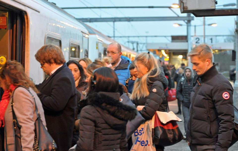 Commuters board a Greater Anglia train at Shenfield in Essex (PA)