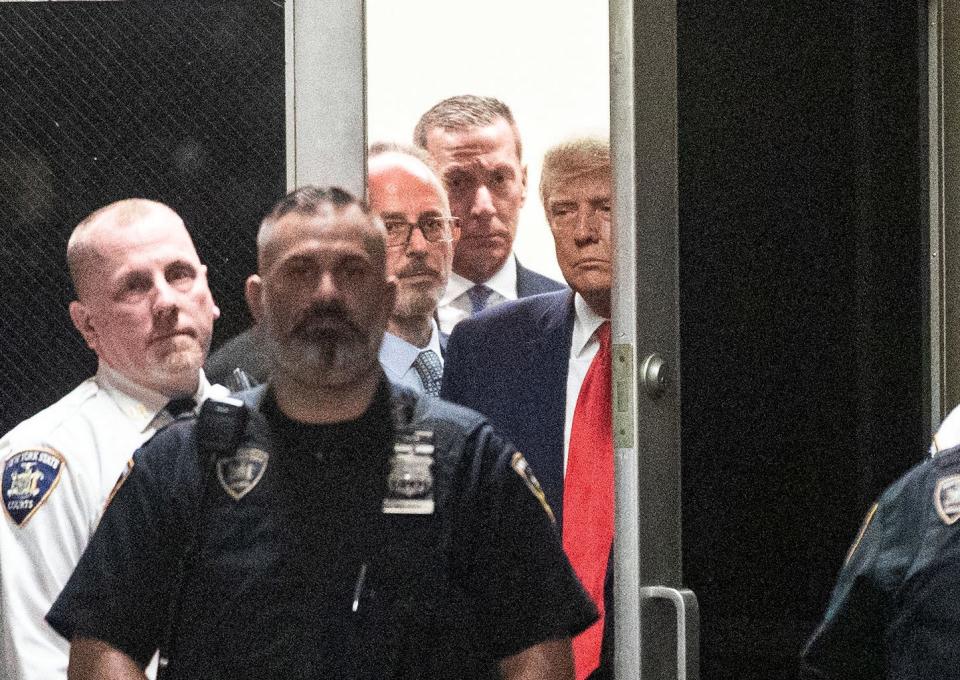 Former President Donald Trump enters court for his arraignment.