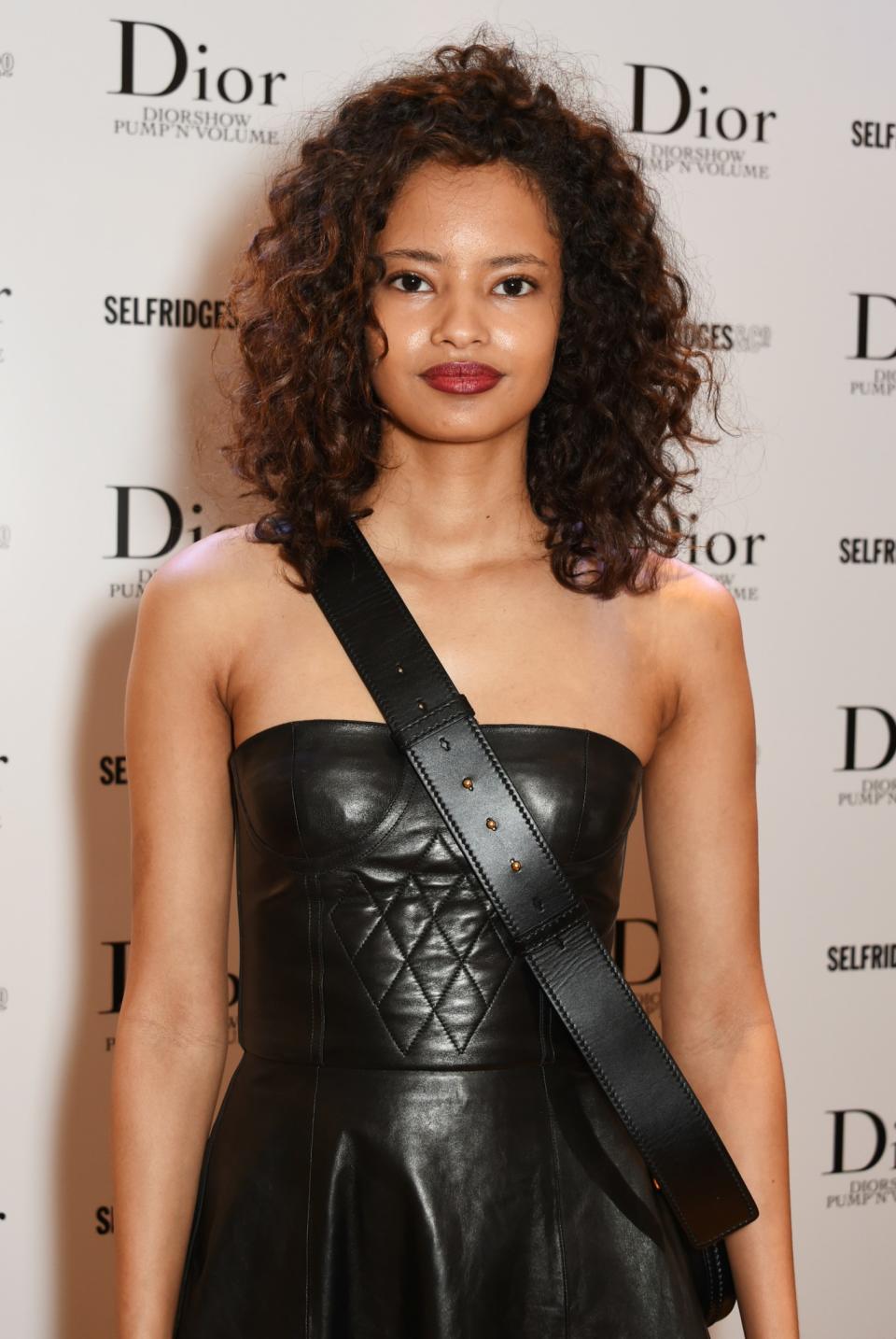 <p>The Kenyan-born British model embraced her natural hair and sported this lush, curly ‘do to the launch of the Dior Pump ‘N’ Volume Mascara in London. Her natural-looking makeup and bold, cherry-red lips add the finishing touches. (Photo: Getty Images) </p>