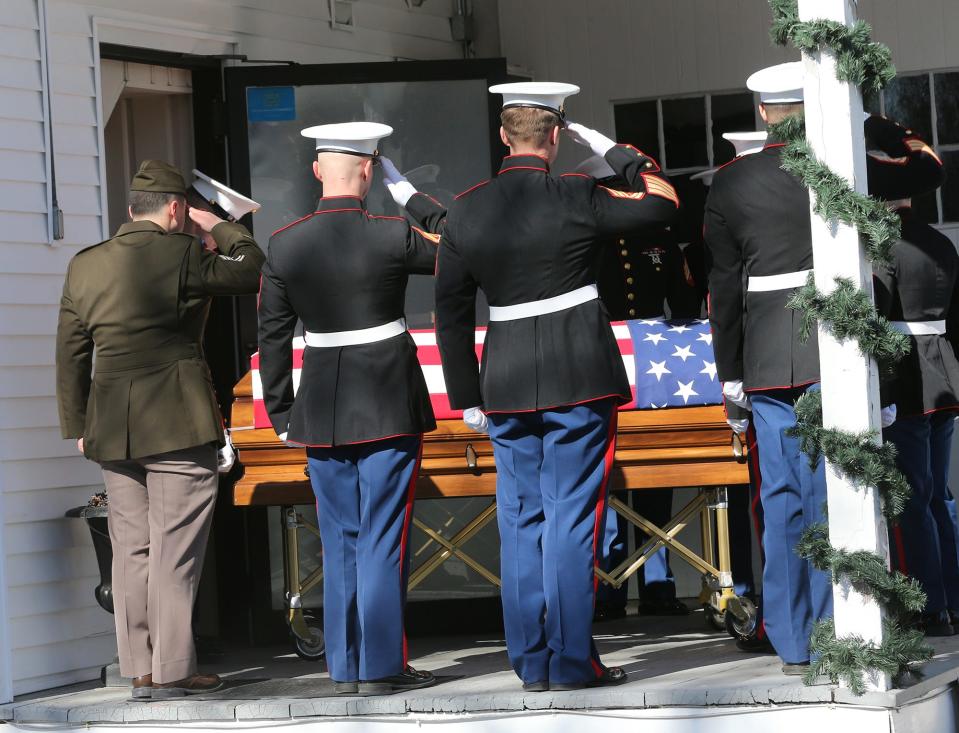 Marines salute late Marine Capt. Jack Casey, who died in a helicopter crash with four other Marines, upon arrival at Wiggin-Purdy-McCooey-Dion Funeral Home in Dover Tuesday, Feb. 20, 2024.