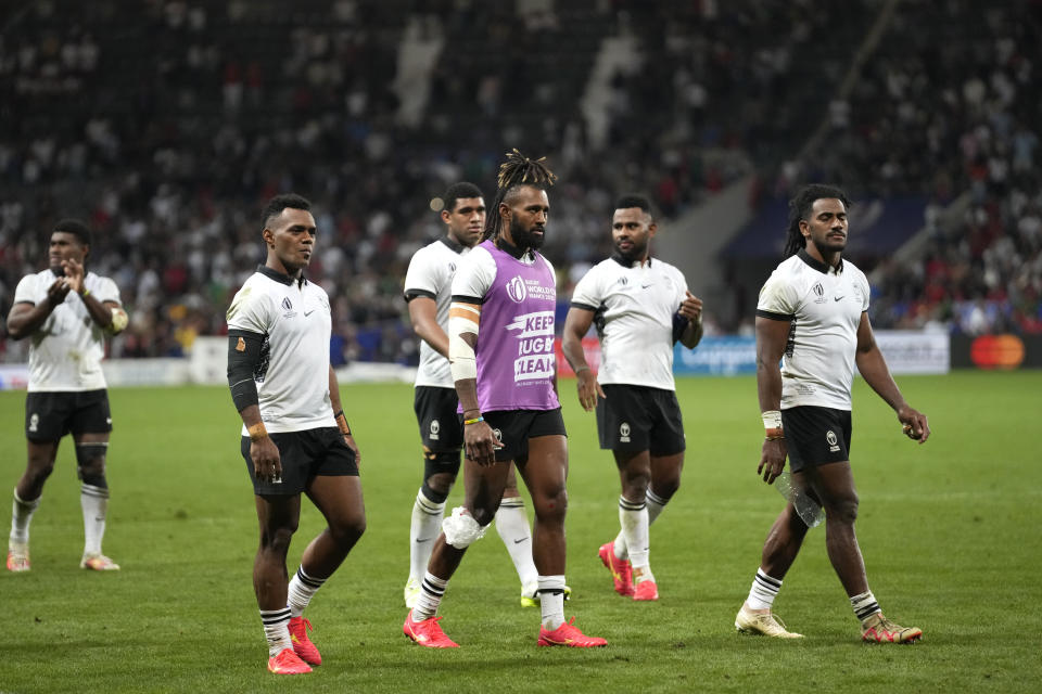 Fiji's captain Waisea Nayacalevu, centre, with his teammates walk around the pitch after the Rugby World Cup Pool C match between Fiji and Portugal, at the Stadium de Toulouse in Toulouse, France, Sunday, Oct. 8, 2023. (AP Photo/Pavel Golovkin)