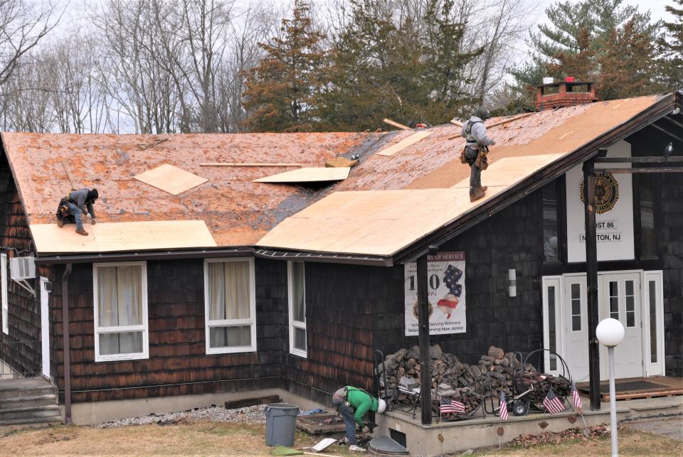 A crew from Momentum Solar of South Plainfield works to put down new plywood sheathing for the roof of Newton American Legion Post 86 on Wednesday, March 16. The work and materials were coordinated by Lowe's Home Improvement as part of its Hometown Projects program which range from single homes to community parks and neighborhoods.