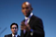 Britain's leader of the opposition Labour Party Ed Miliband listens to a speech by Shadow Business Secretary Chuka Umunna (R) during the annual Labour Party Conference in Brighton, southern England September 23, 2013. (REUTERS/Stefan Wermuth)