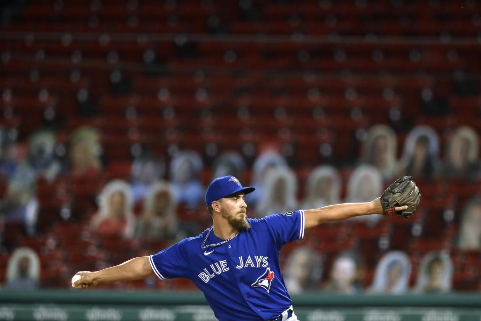 Toronto Blue Jays' A.J. Cole pitches in front of cutouts in the empty stands during the seventh inning of a baseball game against the Boston Red Sox, Friday, Aug. 7, 2020, in Boston. (AP Photo/Michael Dwyer)