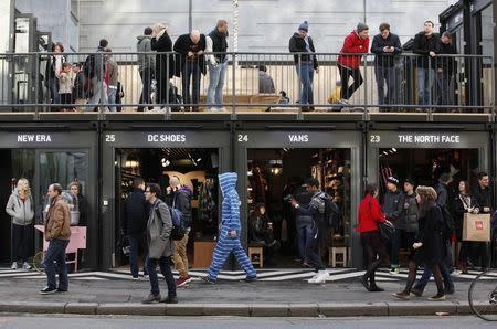 People walk past Boxpark Shoreditch shopping mall on its opening day in London December 3, 2011. REUTERS/Suzanne Plunkett