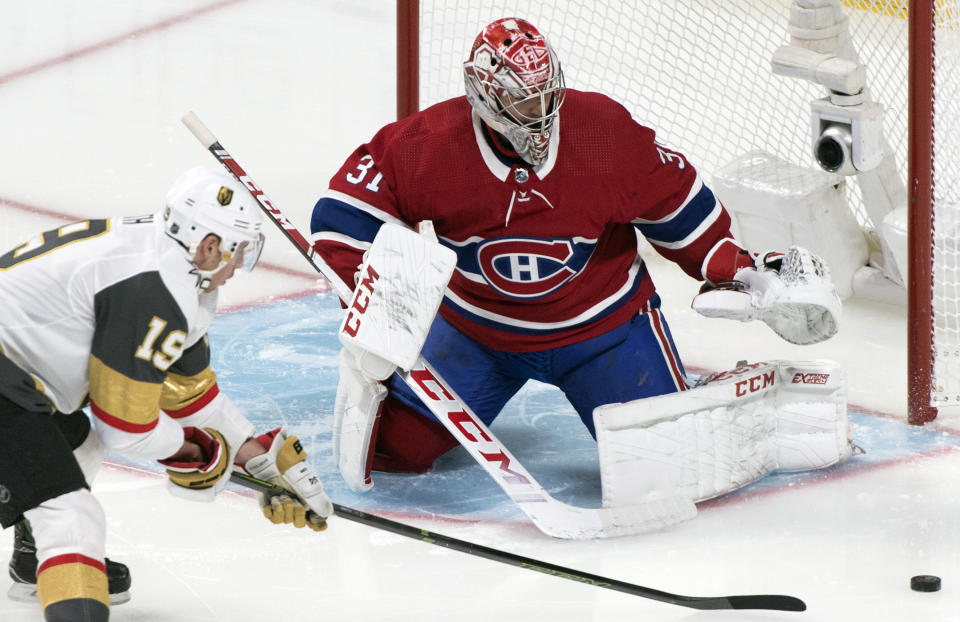 Vegas Golden Knights' Reilly Smith, left, moves in against Montreal Canadiens goaltender Carey Price during first-period NHL hockey game action in Montreal, Saturday, Jan. 18, 2020. (Graham Hughes/The Canadian Press via AP)