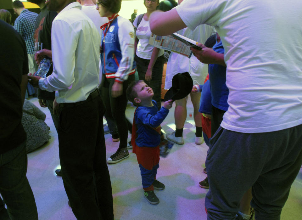 A boy dressed as Superman stands among other visitors to the Comic Con Africa event, a three-day comic book and pop culture convention in Johannesburg, South Africa, on Saturday, Sept. 15, 2018. Wonder Woman and other usual superheroes were in abundance, but also some African characters seemingly sparked by the success of Marvel's "Black Panther" film.(AP Photo/Christopher Torchia)