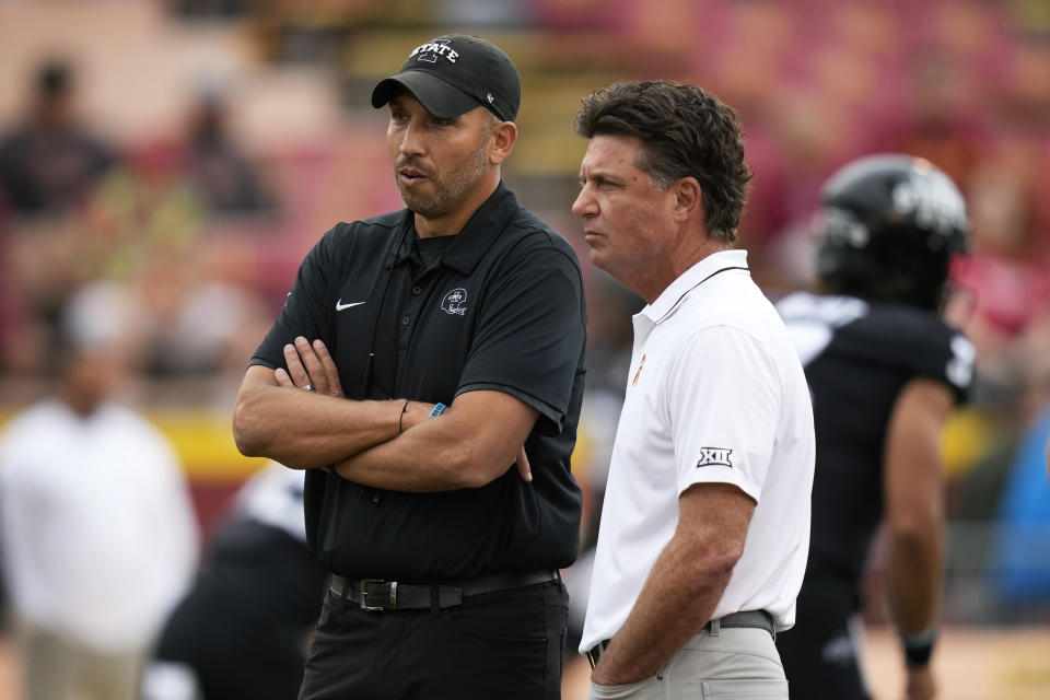 Iowa State head coach Matt Campbell talks with Oklahoma State head coach Mike Gundy, right, before an NCAA college football game, Saturday, Sept. 23, 2023, in Ames, Iowa. (AP Photo/Charlie Neibergall)