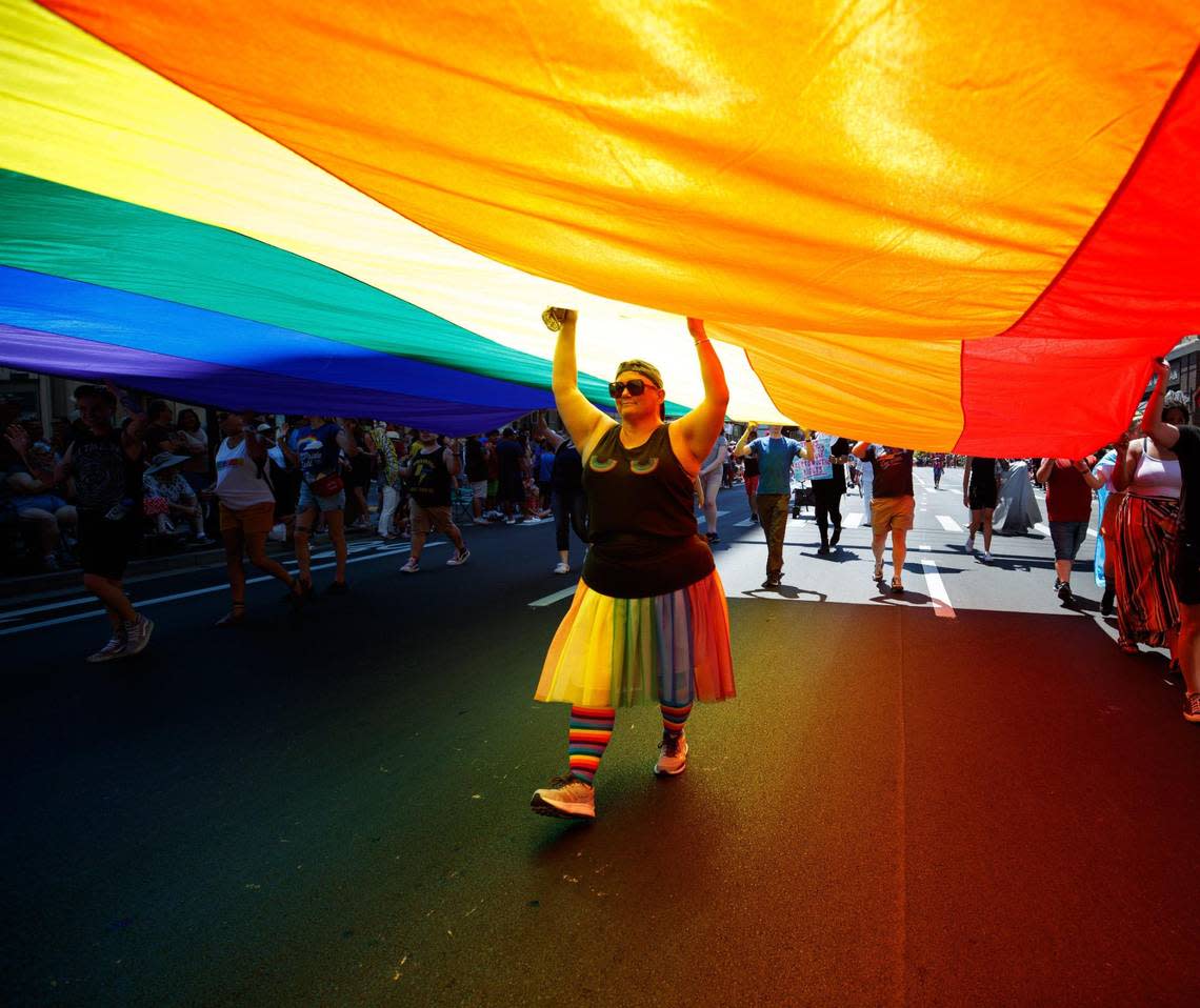 A large rainbow flag is held up during the City of Lexington’s Fourth of July celebration parade on Monday, July 4, 2022, on Main Street in Lexington, Kentucky.