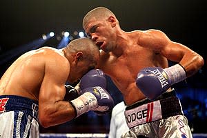 Juan Manuel Lopez (R) trades blows with Orlando Salido during their WBO featherweight title fight