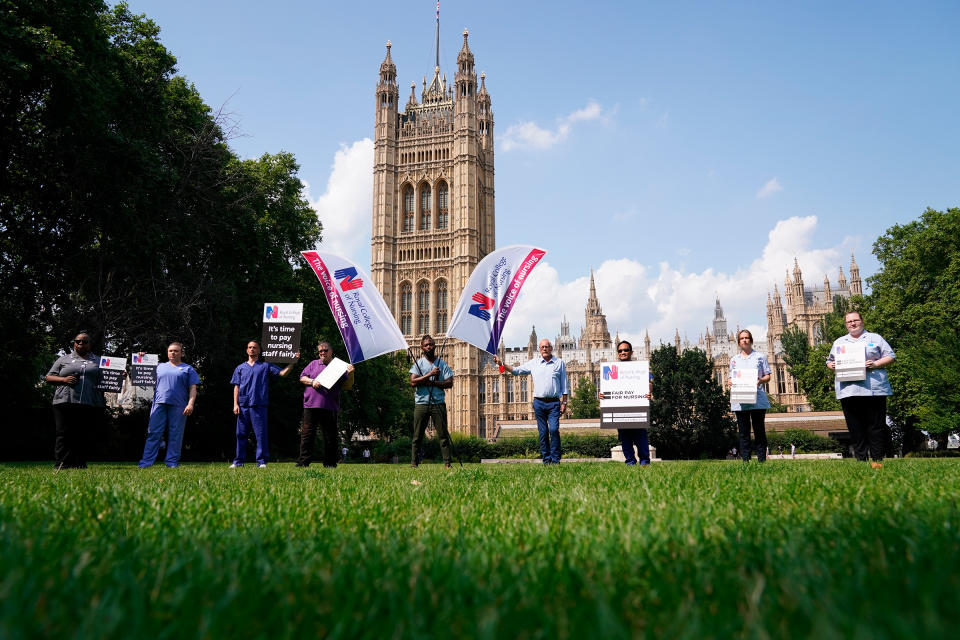 Nurses with placards outside the Royal College of Nursing in Victoria Tower Gardens, London, following the government's announcement of the NHS pay offer, on July 21, 2021.<span class="copyright">Jonathan Brady—PA Wire/AP</span>