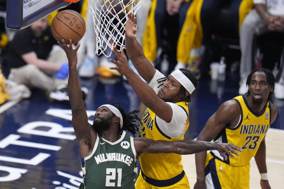 Milwaukee Bucks guard Patrick Beverley (21) drives to the basket past Indiana Pacers center Myles Turner (33) during the first half in Game 6 in an NBA basketball first-round playoff series, Thursday, May 2, 2024, in Indianapolis. (AP Photo/Michael Conroy)