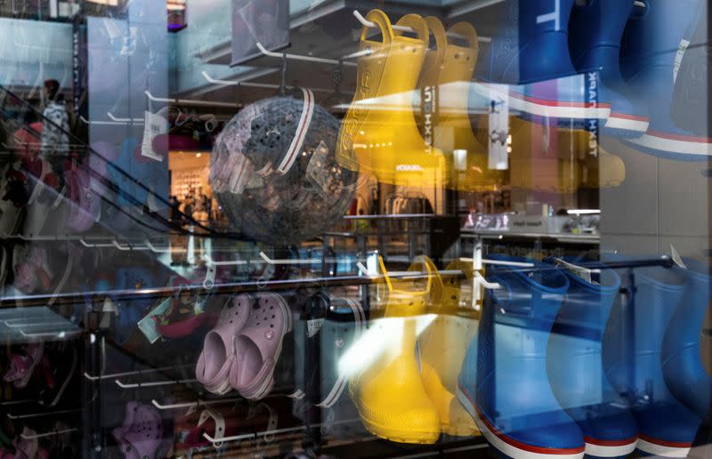 FILE PHOTO: A view through a shop window shows Crocs shoes at a closed store in a shopping mall in Moscow