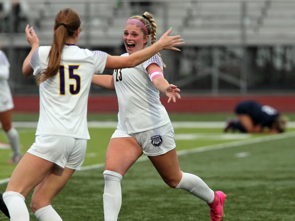 Bloom-Carroll's Charlie Conrad, left, and Maddy Jackson celebrate the Bulldogs' victory over Granville on Saturday.