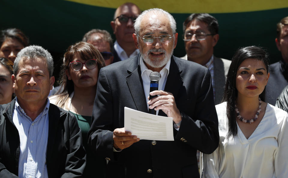 Accompanied by Gustavo Pedraza, left, Vice-Presidential candidate of the Comunidad Ciudadana party and Shirley Franco, right, Vice-President candidate of the Bolivia Dijo No party, opposition presidential candidate Carlos Mesa, center, reads a statement from opposition parties in the wake of President Evo Morales' declaring himself the outright winner of the country's presidential election, in La Paz, Bolivia, Thursday, Oct. 24, 2019. Morales victory declaration would give him a fourth straight term, after a vote that has sparked days of protests by both his opponents and supporters over accusations of fraud. (AP Photo/Juan Karita)