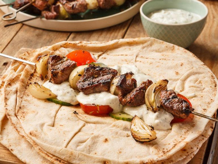 Lamb steaks marinated in lemon, garlic and oregano is threaded on to skewers with thick wedges of shallot in this recipe. These kebabs are great stuffed into some flatbread with tzatziki and salad.Serves 4 to 6Prep: 15 minutes plus marinating Cook: 10 minutes600g lamb leg steaks, cut into bite-sized pieces 2 tbsp olive oil 1 lemon, zest and juice 3 cloves garlic, crushed 2 tsp dried oregano 6 shallots, peeled and quartered through the root salt and freshly ground black pepperTo serve6 flatbreads, wraps or pitta bread a tub of tzatziki some slices of tomato and cucumberYou also need 6 skewers for the kebabs. If using wooden ones, soak them in water for an hour so they don’t burn on the grill.Add the lamb to a bowl and mix together with the olive oil, lemon zest and juice, garlic and oregano. Season with a good grind of salt and pepper, stir well and cover with cling film. Leave to marinate in the fridge for a couple of hours or longer if you have time.When you are ready to cook, you need to heat a barbecue until it is really hot. You can also cook these indoors on a cast iron griddle that’s preheated on the hob until smoking hot.Thread the lamb and shallot quarters onto the skewers and grill for about 8-9 minutes, turning a few times so they cook evenly.While the kebabs are cooking, warm the flatbreads or pittas by wrapping them in foil and laying on the grill, or warming in the oven.To serve, use a fork to pull the meat and shallot from each skewer and into flatbreads or pittas. Top with a little tzatziki and a cucumber and tomato salad and tuck in.Recipe from ukshallot.com