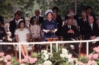 <p>Caroline (pink headband), sits behind Queen Elizabeth II and her mother, Jacqueline Kennedy, at the inauguration of Britain's JFK Memorial at Runnymede. </p>