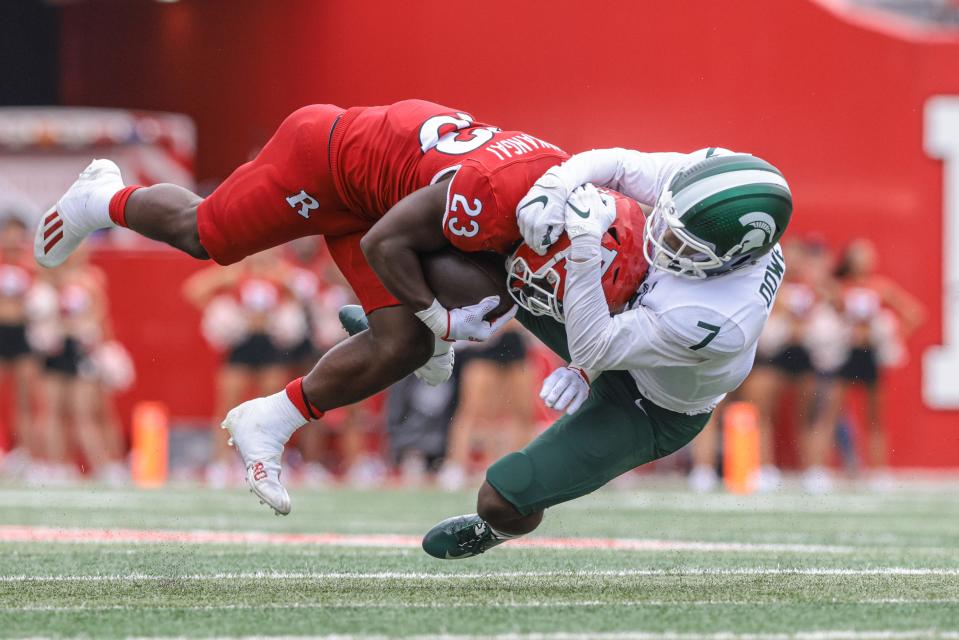 Oct 9, 2021; Piscataway, New Jersey, USA; Rutgers Scarlet Knights running back Kyle Monangai (23) is tackled by Michigan State Spartans safety Michael Dowell (7) during the second half at SHI Stadium.