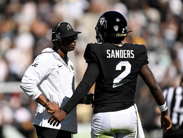 <p>RJ Sangosti/MediaNews Group/The Denver Post via Getty</p> Deion Sanders talks with his son Colorado Buffaloes quarterback Shedeur Sanders