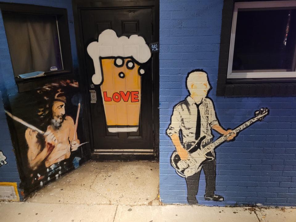 A mural by artist Tom West on the exterior of Providence club The Parlour includes drummer Nick Iddon, seen at left.