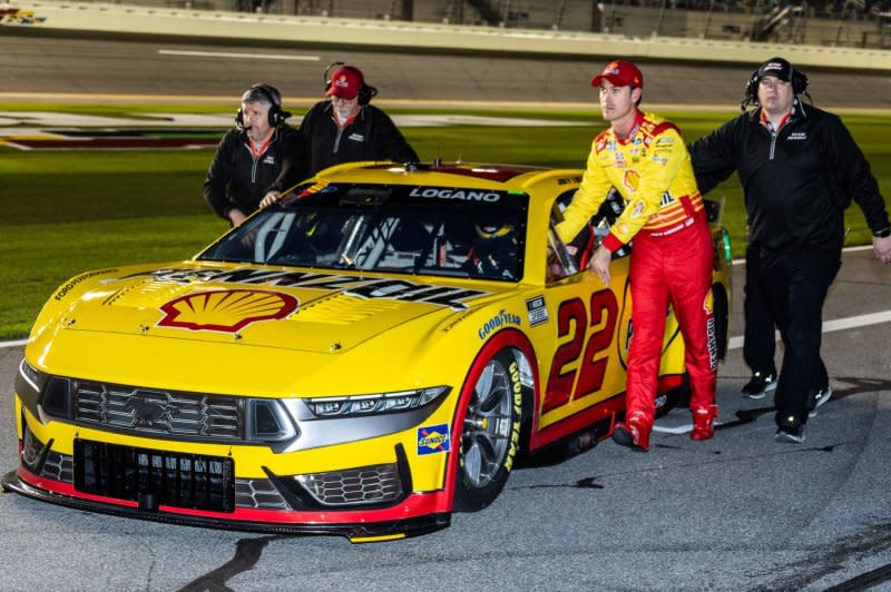 Joey Logano (R) helps push his car to qualify for the 66th Daytona 500 on Wednesday in Daytona Beach, Fla. Photo by Edwin Locke/UPI