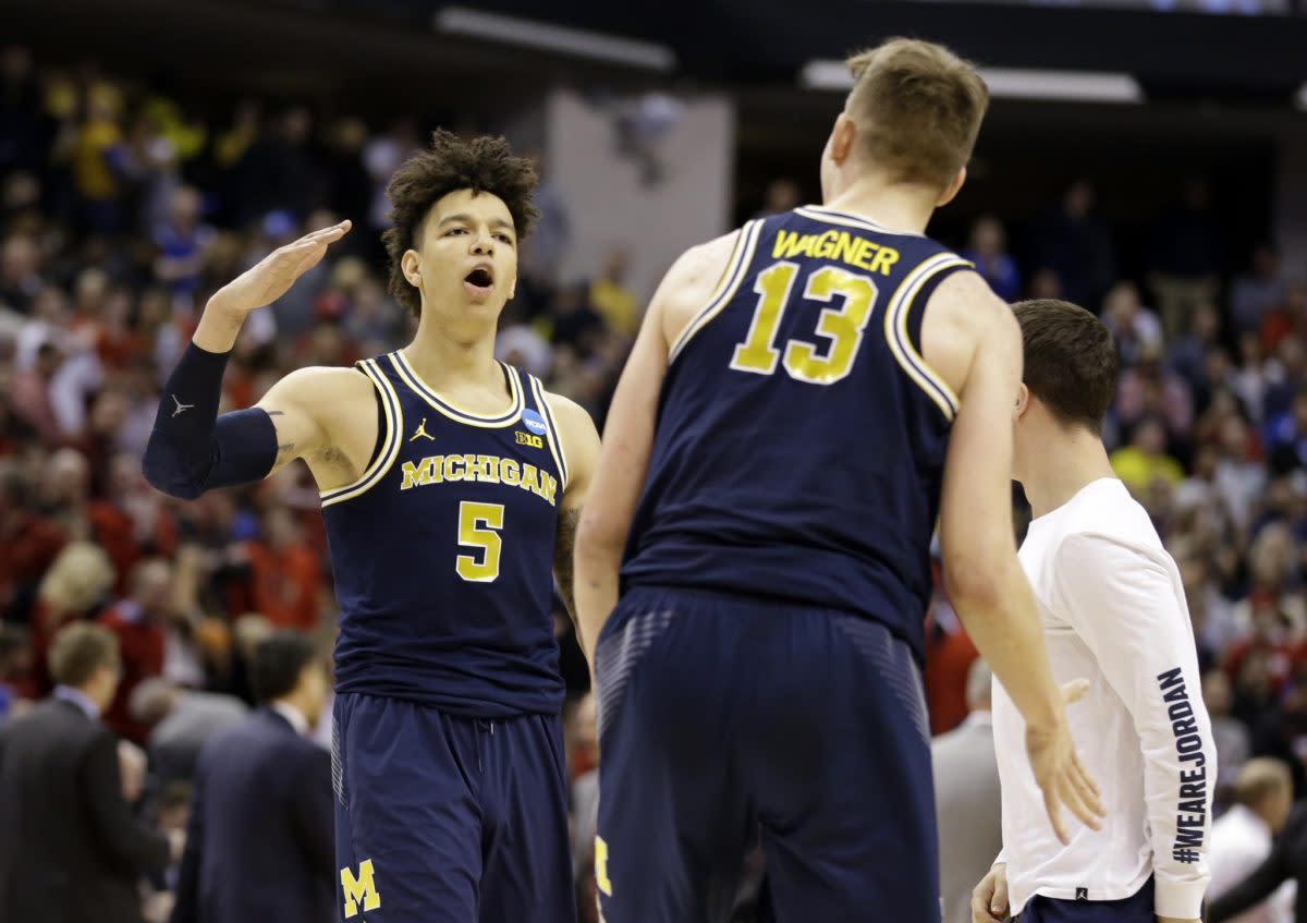 Michigan will get one of its two promising big men back next season. (AP)