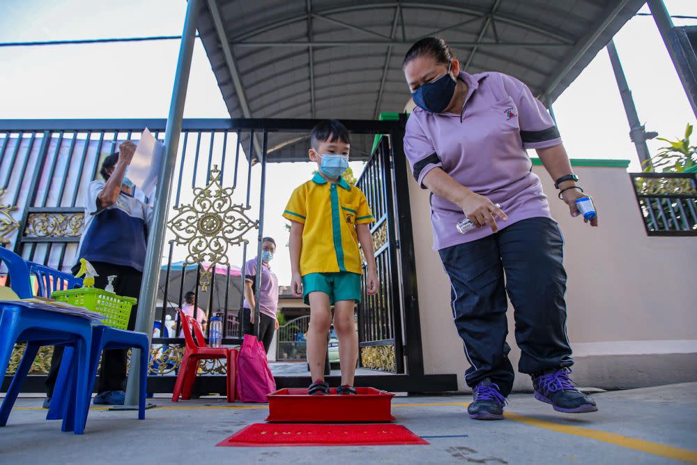 Pre-schoolers adhere to strict standard operating procedures on the first day of school at Mayter Kindergarten in Cheras on July 1, 2020. — Picture by Hari Anggara