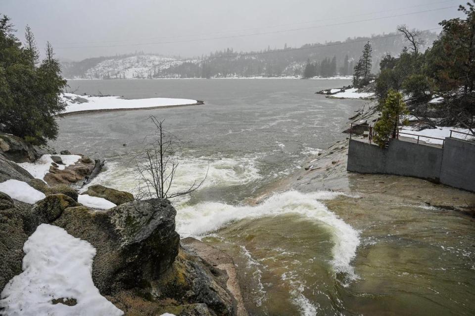 Fresh mountain snowmelt flows from Willow Creek into Bass Lake in Madera County during a rainstorm on Tuesday, March 14, 2023.