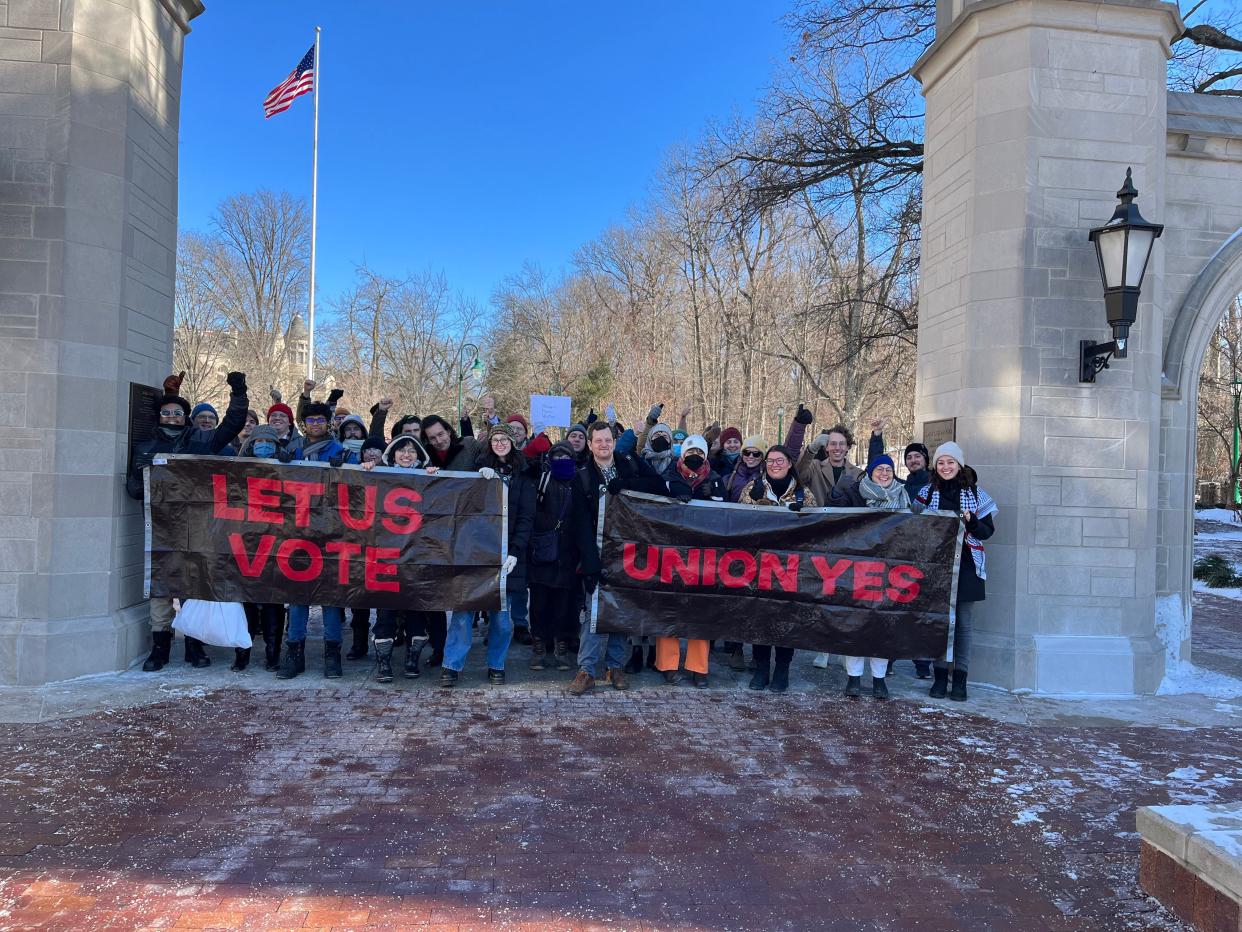 Indiana Graduate Workers Coalition members stand outside Indiana University's Sample Gates on Jan. 16, 2024.