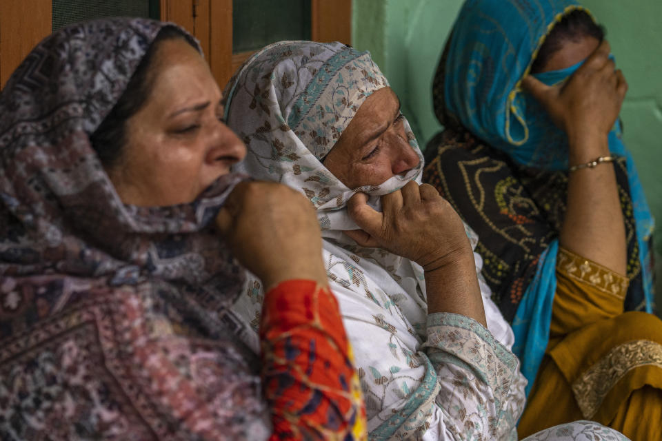 Unidentified relatives of Waseem Sarvar Bhat, an Indian army solider who was killed in a gunfight with suspected rebels, grieve at his residence in Bandipora, north of Srinagar, Indian controlled Kashmir, Saturday, Aug. 5, 2023. Three Indian soldiers were killed in a gunbattle with rebels fighting against New Delhi’s rule in Kashmir, officials said Saturday, as authorities stepped up security on the fourth anniversary since India revoked the disputed region’s special status. (AP Photo/Dar Yasin)